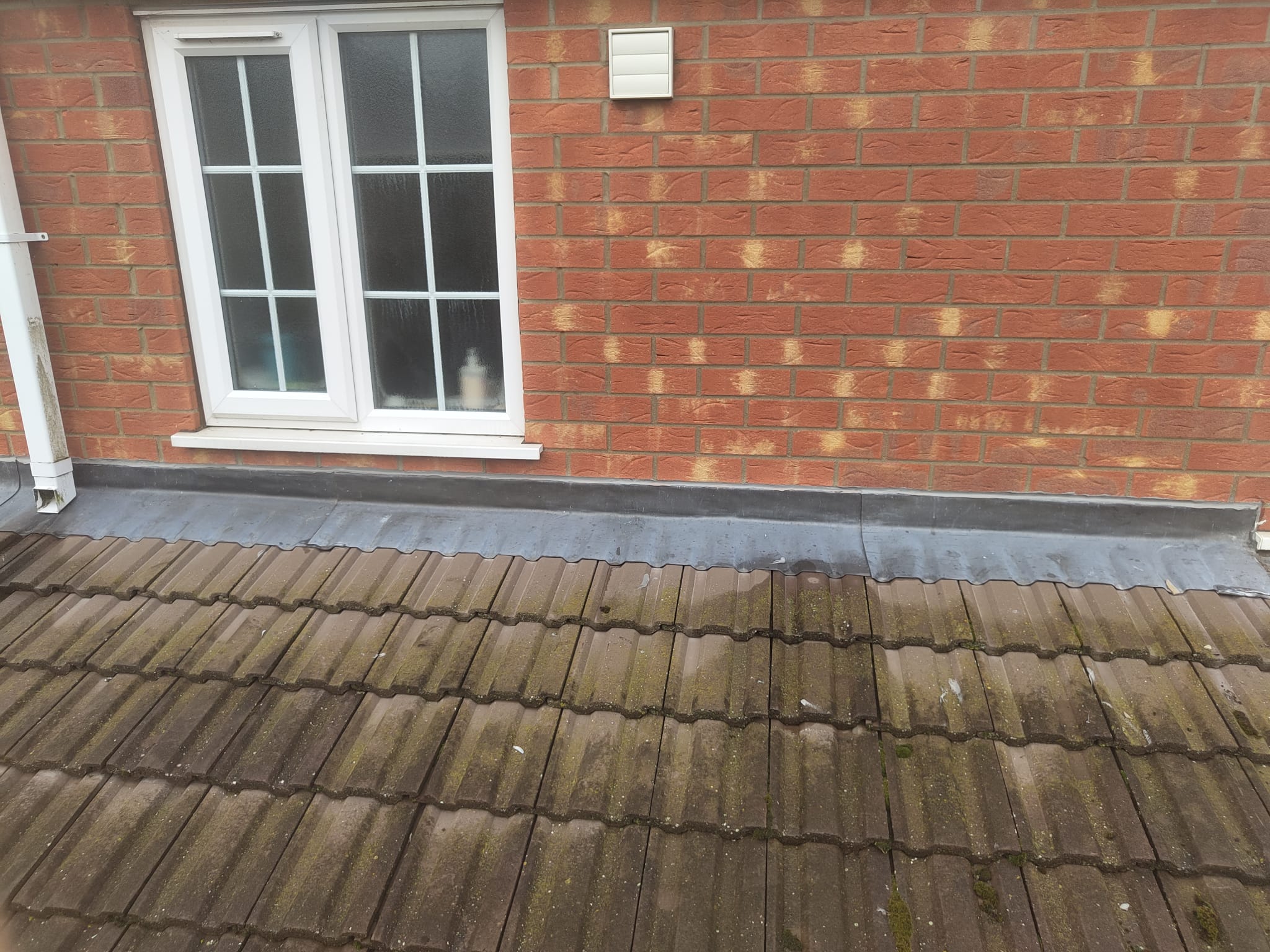 Lead flashing where a tiled roof meets a brick wall