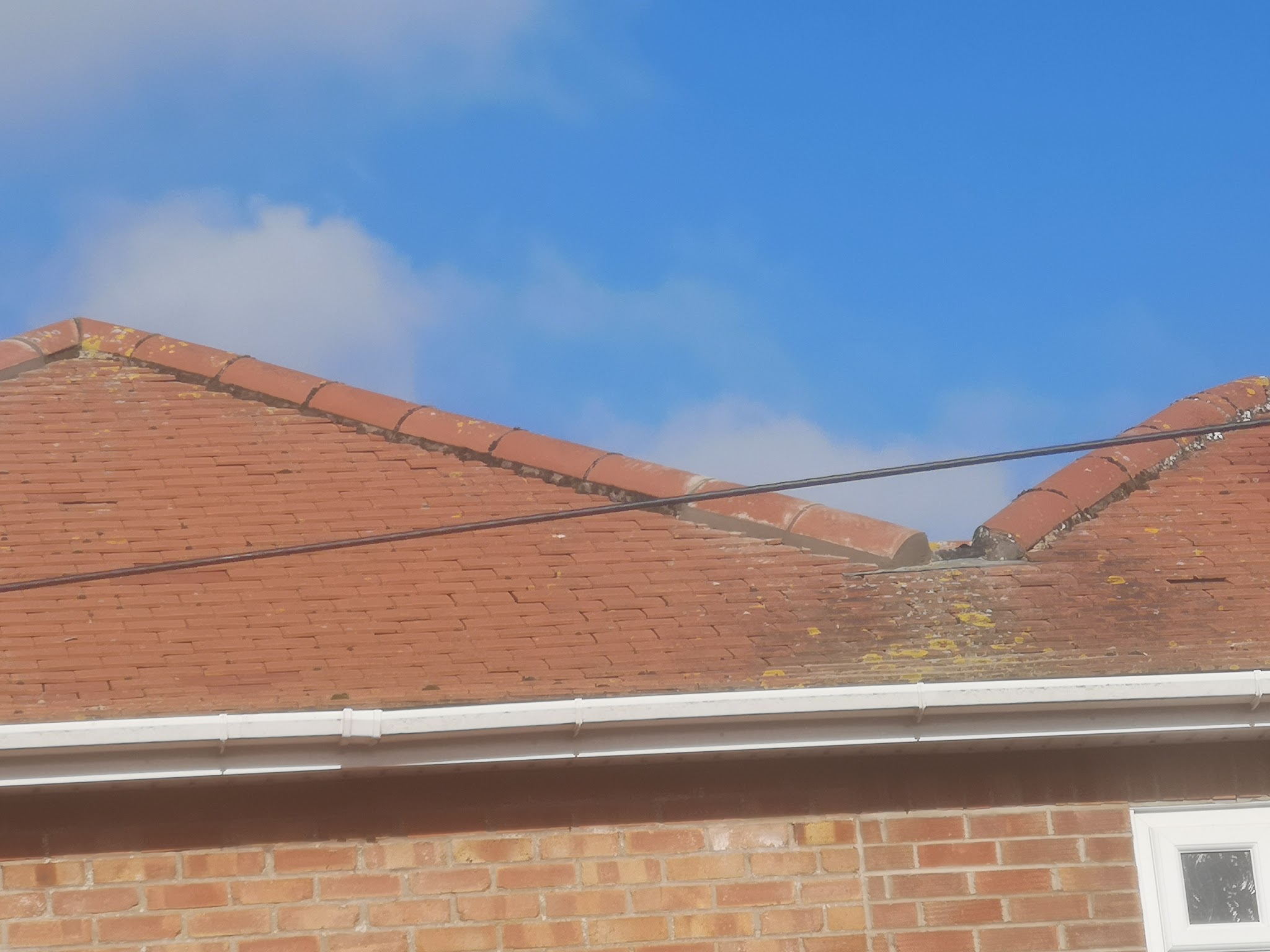A red plain-tile roof and ridge on a bungalow